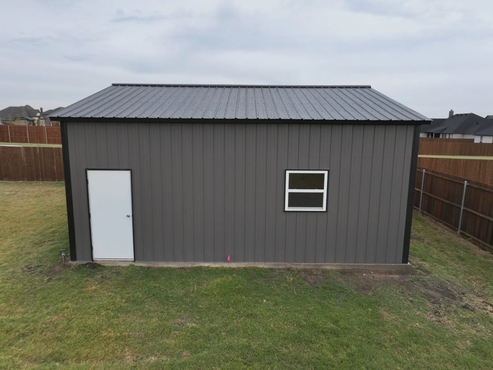 24x25 Black and Grey Tubular Metal Building in Godley, TX. 24x25 Black and Grey Tubular Metal Building in Godley, TX.