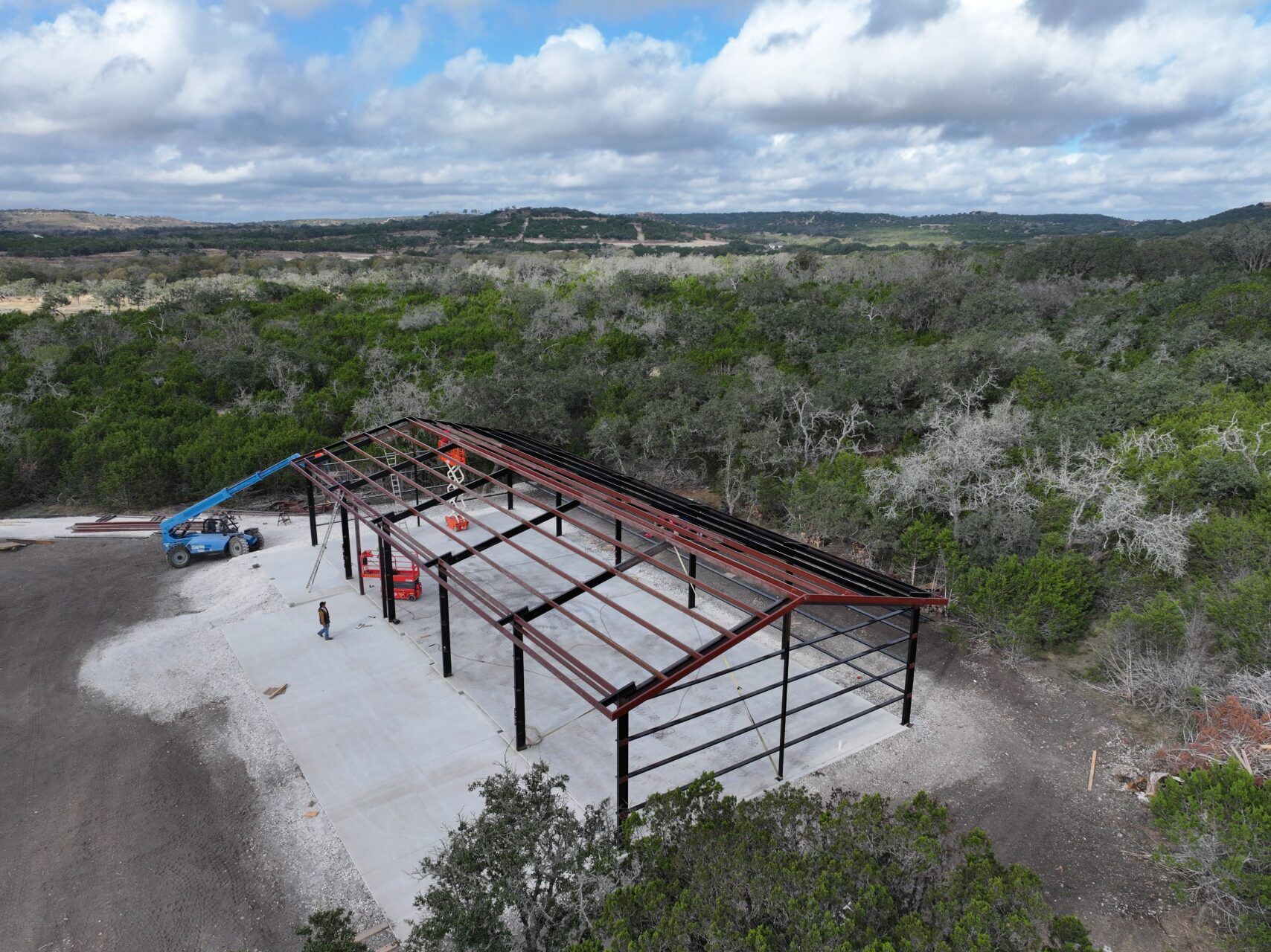 40x100 Custom Weld Up Red Iron Steel Garage in Kerrville, Texas.